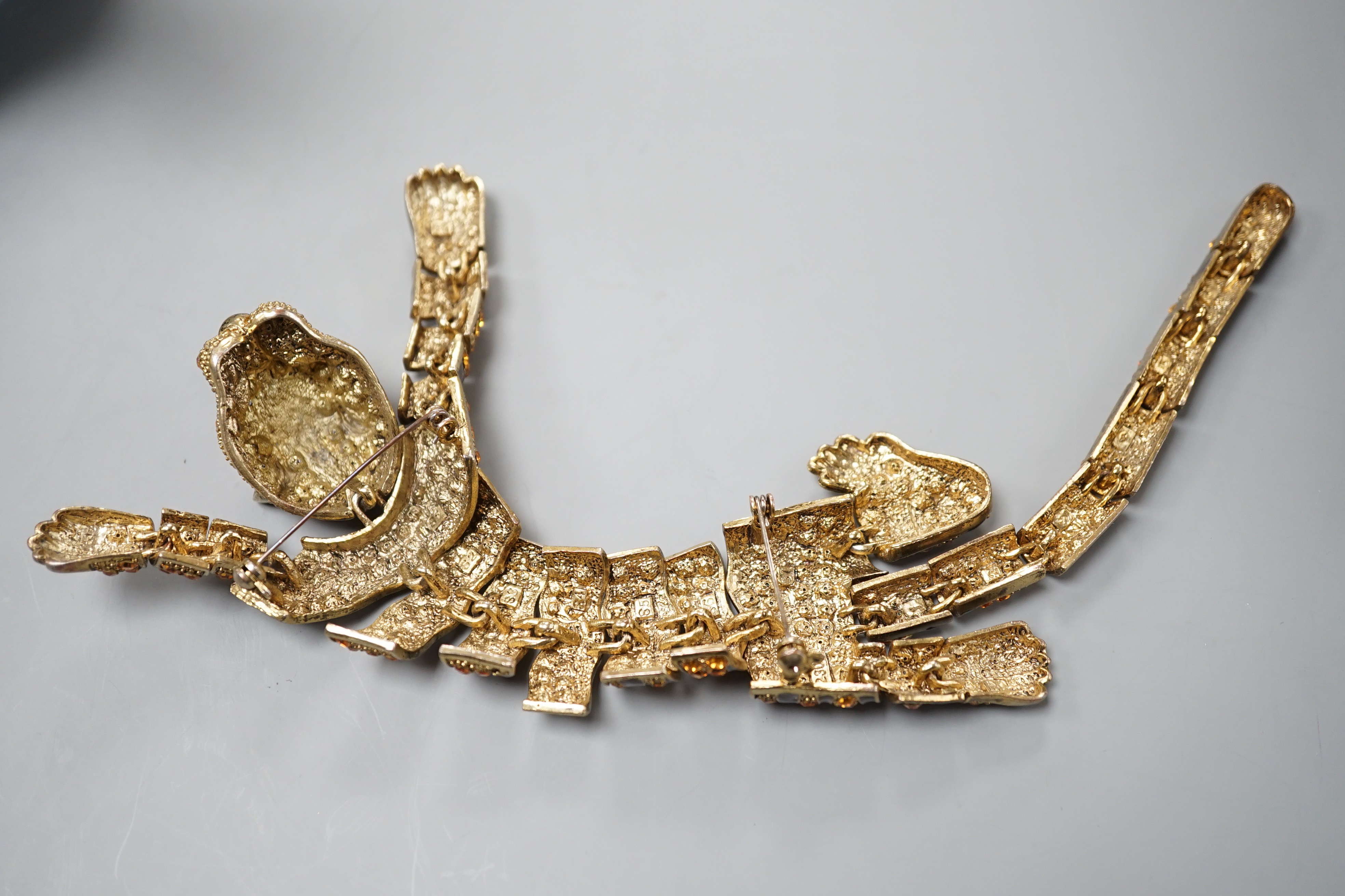 A costume gilt metal and paste set tiger shoulder? ornament, 24.5cm.